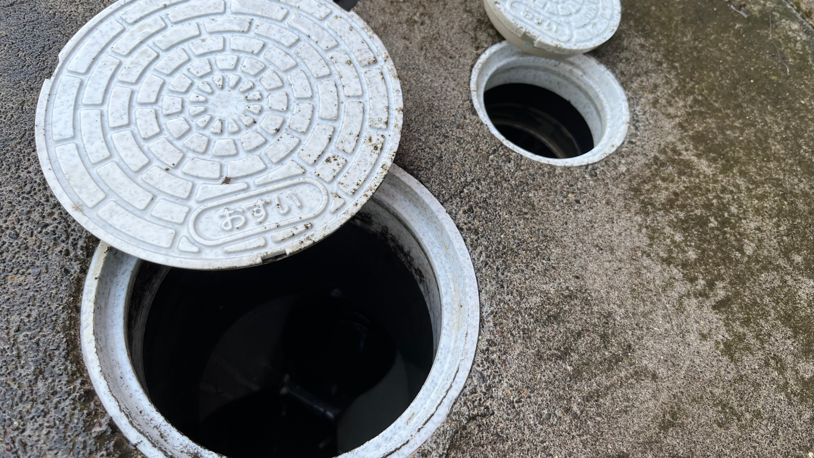 Drain Bros llc shows open manholes used in plumbing work. The image highlights service access points for pipe repair.