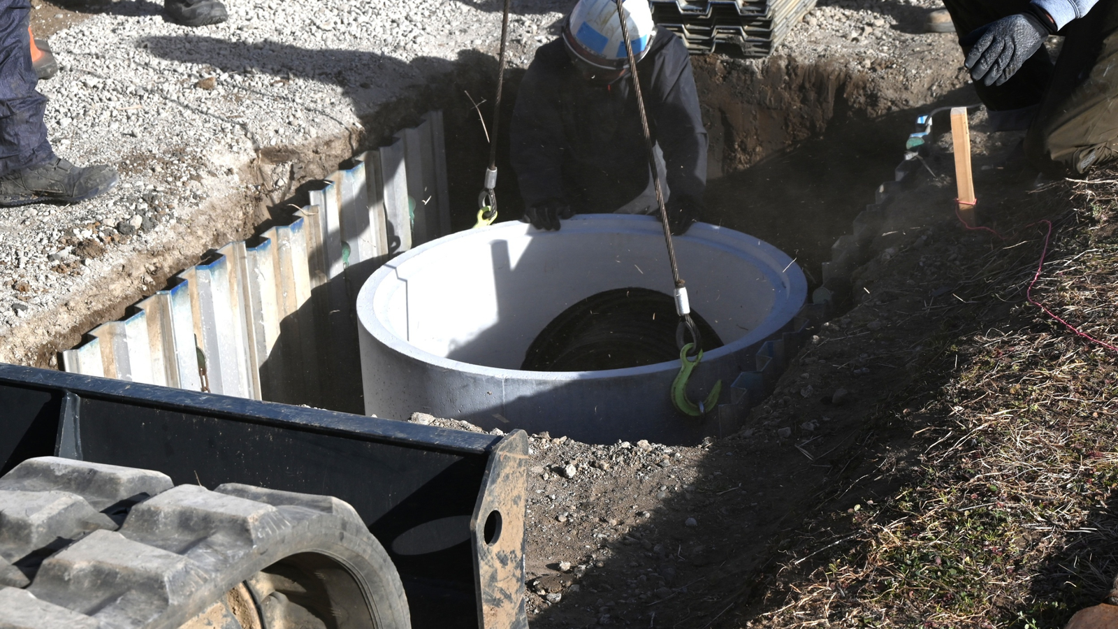 Drain Bros llc team installs a septic system, showing their safe and reliable residential excavation service.