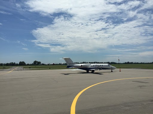 A Drain Bros llc project shows their drainage system work underway at an airport near a parked private jet.