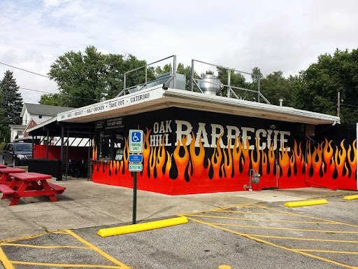 Drain Bros llc offers easy plumbing services near a barbecue restaurant with outdoor seating and parking.