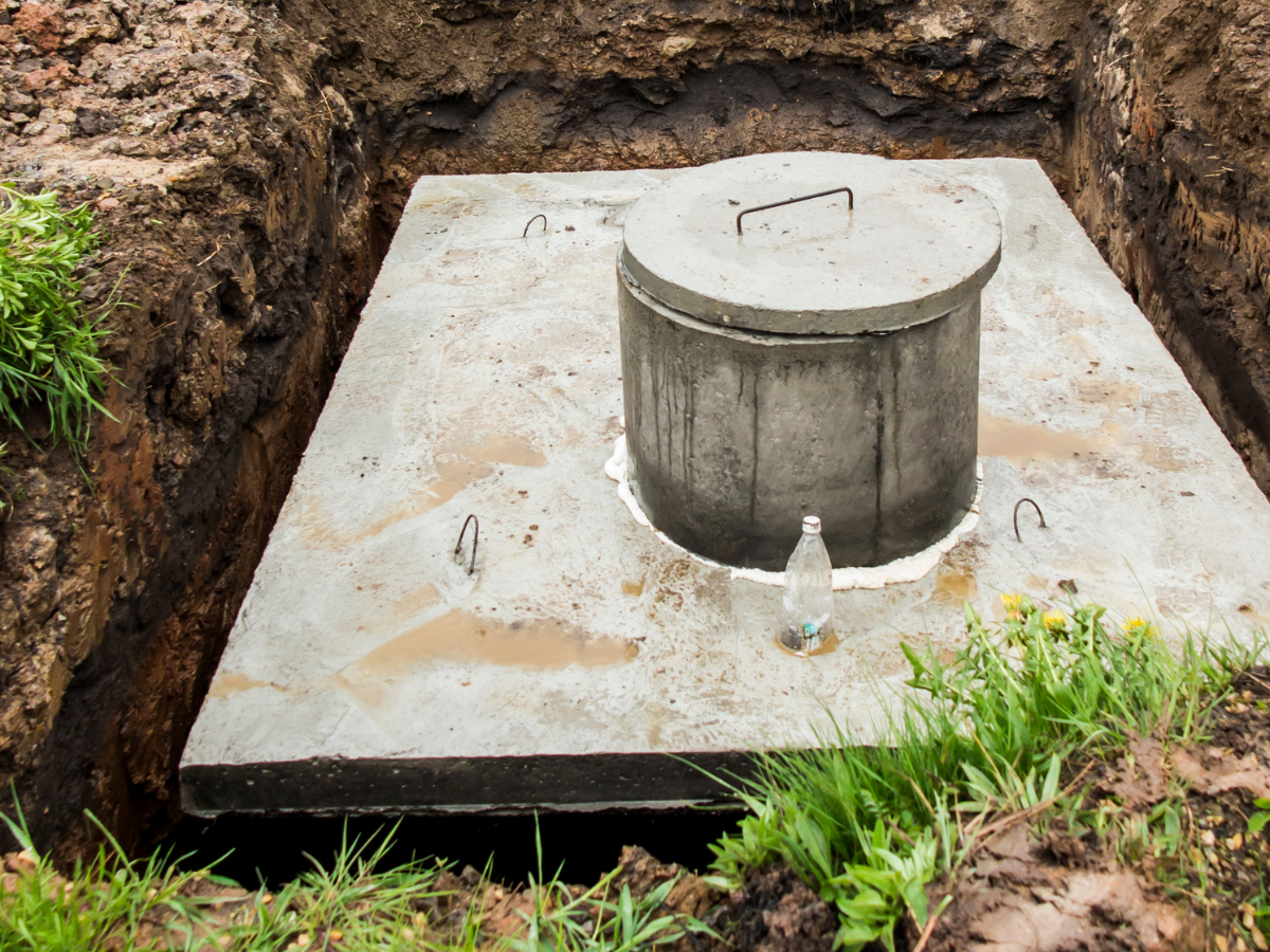 Drain Bros llc installs a septic tank, showing part of the system set up and ground prepared for safe wastewater handling.