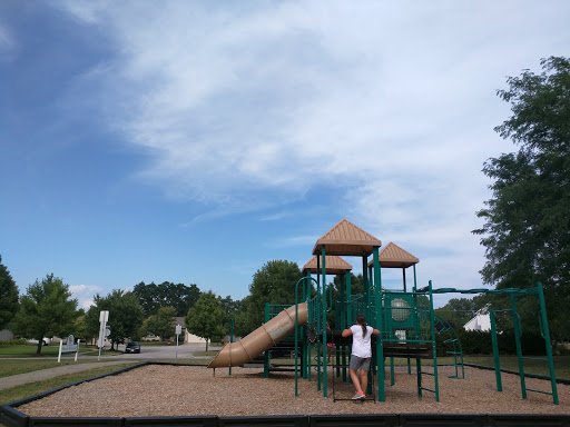 A child plays at a neighborhood park where Drain Bros llc can help if you notice warning signs of sewer line trouble.