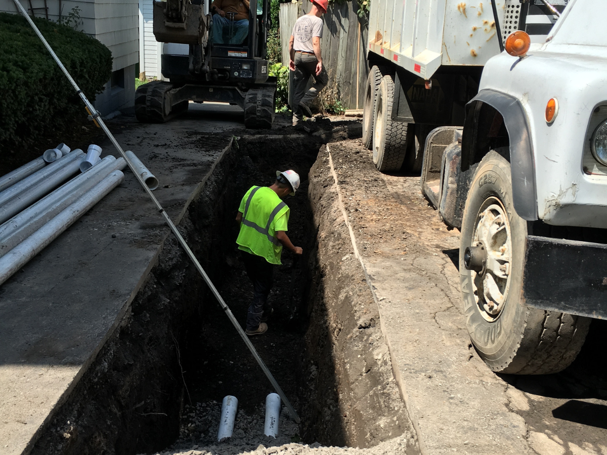 Drain Bros llc workers fix a sewer problem, using pipes and machines to repair damage and restore safe service.