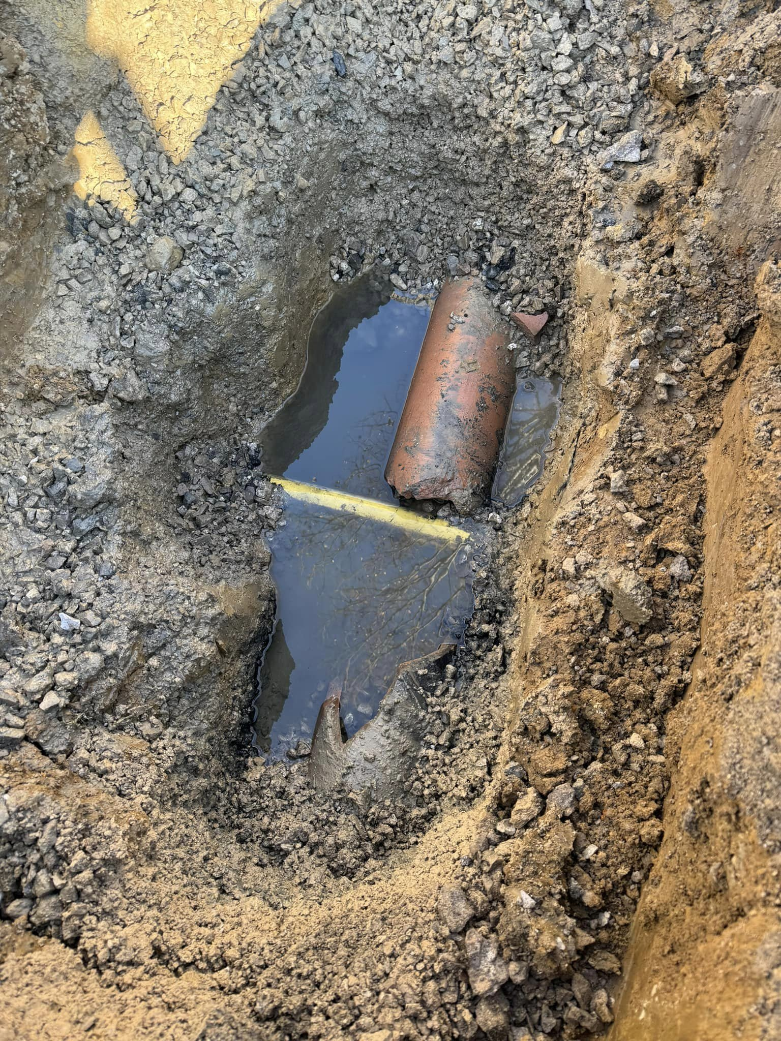 Drain Bros llc fixing sewer line issues, showing damage and repairs needed after a plumbing problem.