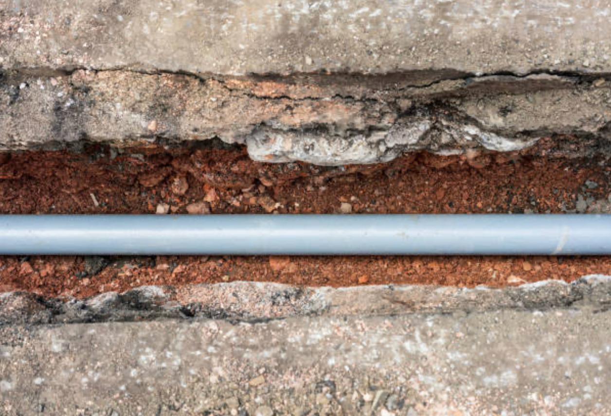 Drain Bros llc can help fix sewer line issues shown by pipe damage in soil and concrete needing excavation work.